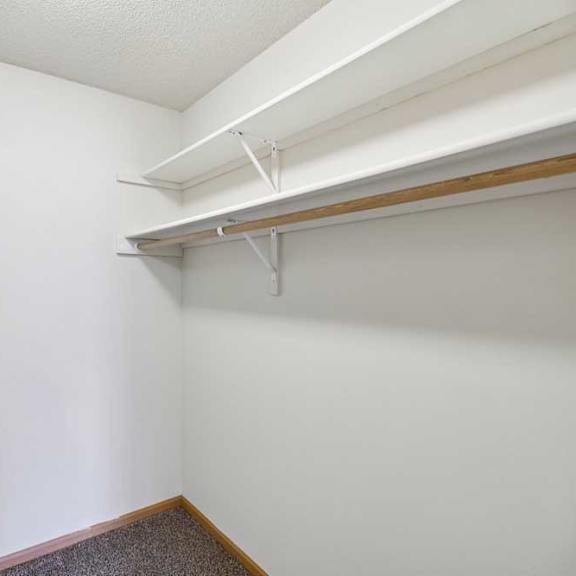 Thumbnail 48 of 48 A white wall with a brown floor and a white ceiling.