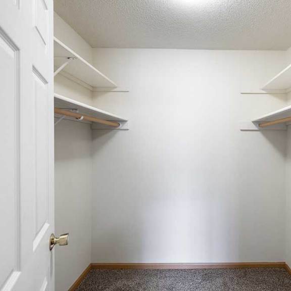 Thumbnail 47 of 48 A white closet with a door and shelves.
