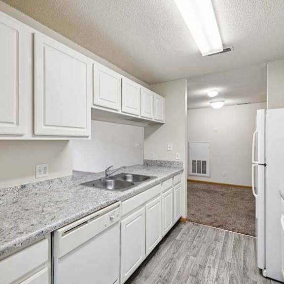 Thumbnail 41 of 48 A kitchen with white cabinets and granite countertops.