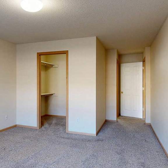 Thumbnail 19 of 28 bedroom with a carpeted floor and walk-in closet