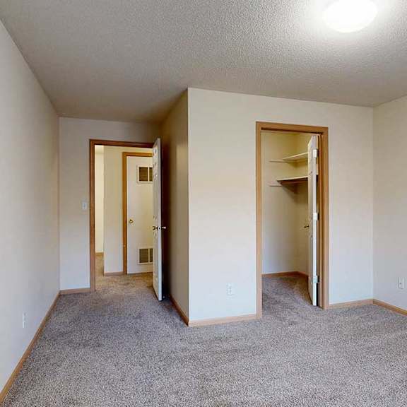 Thumbnail 23 of 28 bedroom with carpeted floor and walk in closet