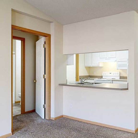 Thumbnail 7 of 28 a kitchen area with a breakfast bar with seating