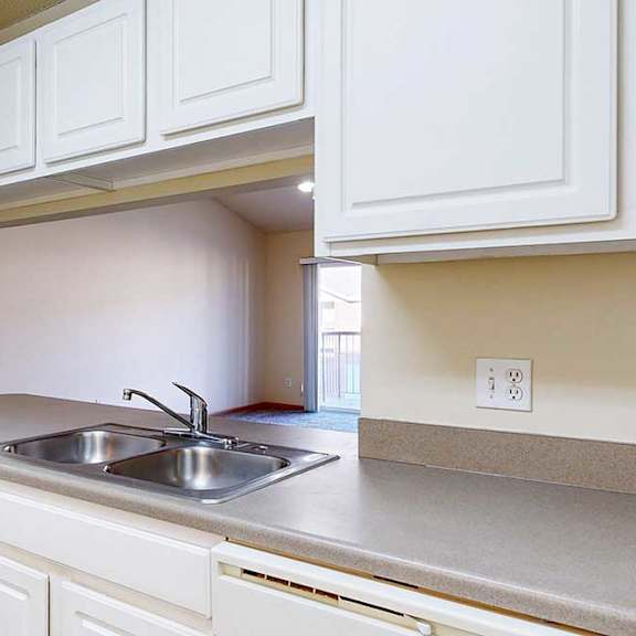 Thumbnail 3 of 28 a kitchen with white cabinets and a stainless steel sink