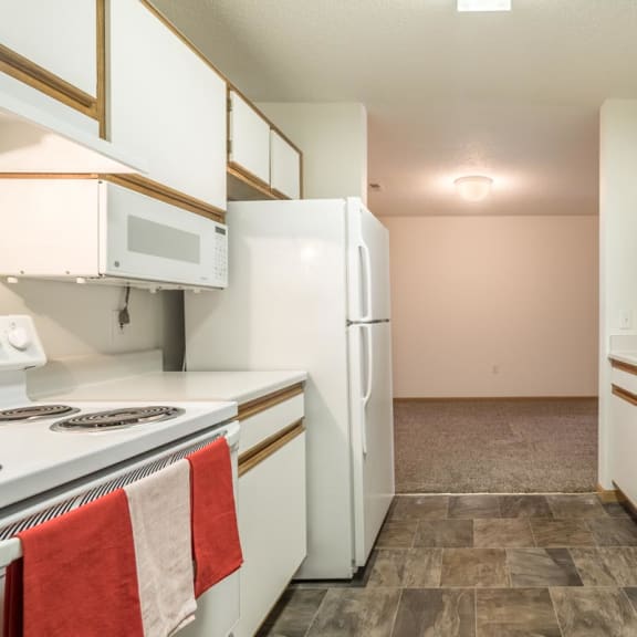 Thumbnail 4 of 17 a kitchen with white appliances and a sink and a refrigerator