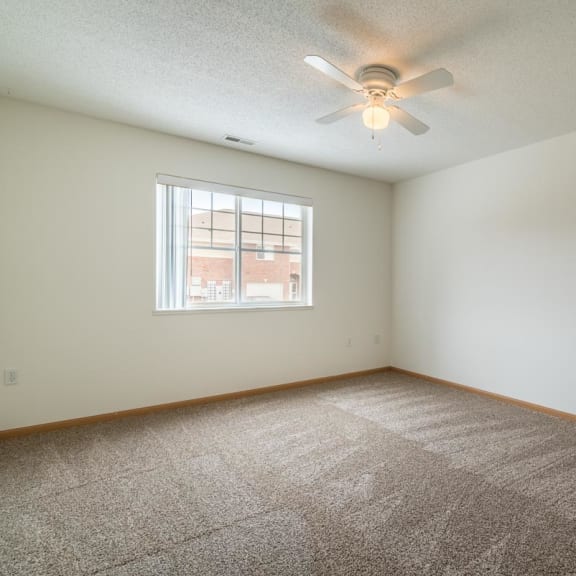Thumbnail 9 of 17 an empty room with a ceiling fan and a window