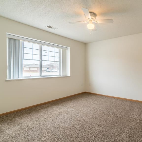Thumbnail 13 of 17 an empty room with a window and a ceiling fan
