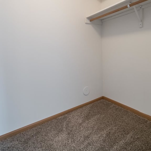 Thumbnail 15 of 17 an empty room with a white wall and a shelf on the wall