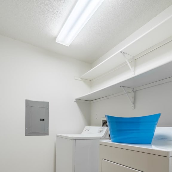 Thumbnail 17 of 17 a laundry room with two washes and a dryer