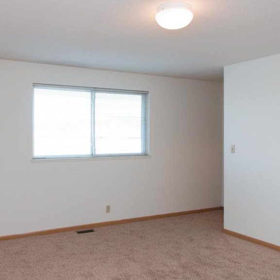 Thumbnail 7 of 16 a large white room with a window and carpet