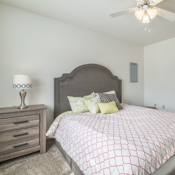 Thumbnail 6 of 8 Master bedroom with ceiling fan and attached bathroom at Northridge Heights in Lincoln