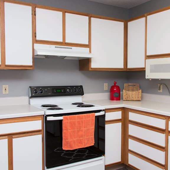 Thumbnail 3 of 7 a kitchen with a stove top oven and a sink