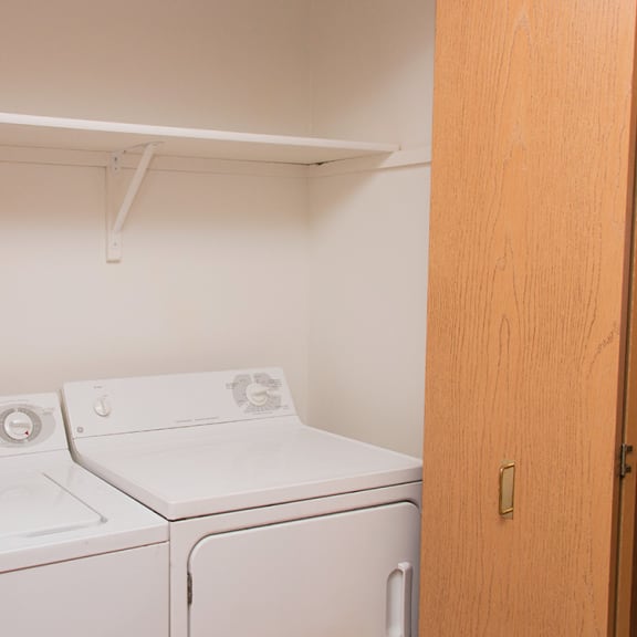 Thumbnail 7 of 7 an empty laundry room with a washer and dryer