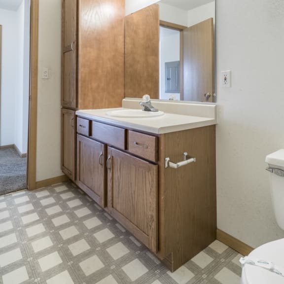 Thumbnail 9 of 11 an empty bathroom with a sink and a mirror