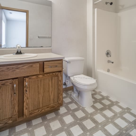 Thumbnail 10 of 11 an empty bathroom with a toilet and a sink