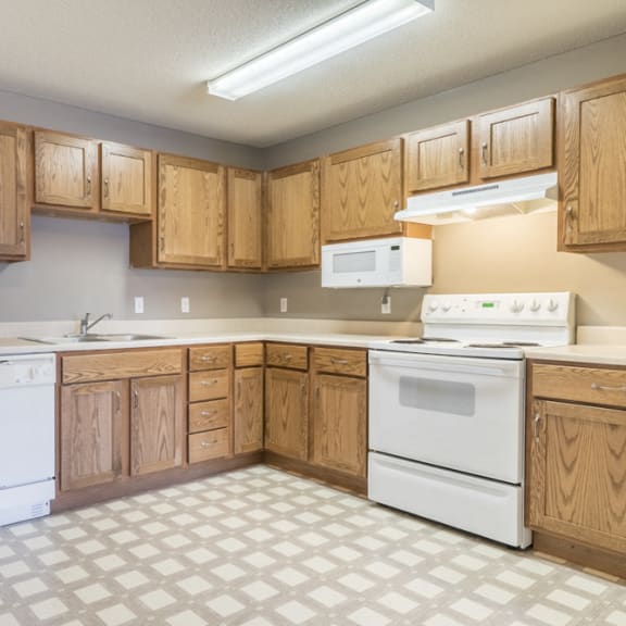 Thumbnail 5 of 11 Kitchen with white appliances and lots of cabinet storage at Northridge Heights in north Lincoln