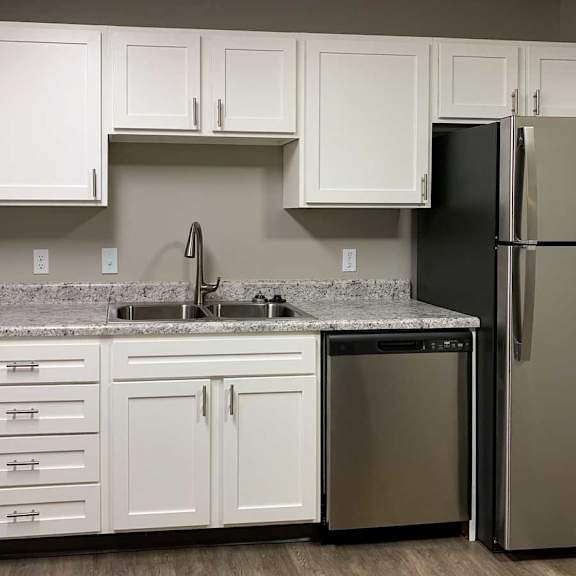 Thumbnail 6 of 21 a kitchen with white cabinets and stainless steel appliances