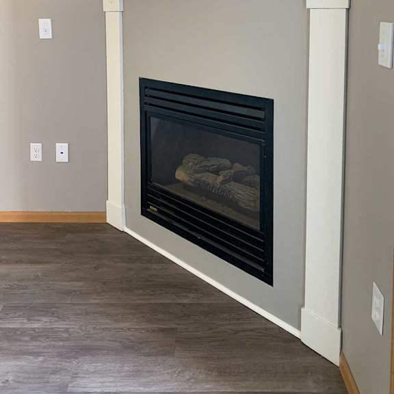 Thumbnail 9 of 21 a fireplace with a grey and white mantle