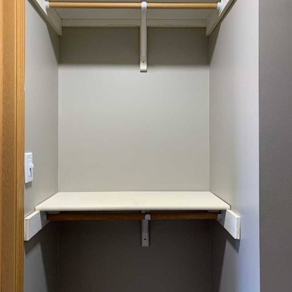 Thumbnail 18 of 21 a walk-in closet with built-in shelving and hanging space