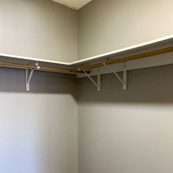 Thumbnail 17 of 21 a walk-in closet with built-in shelving and hanging space