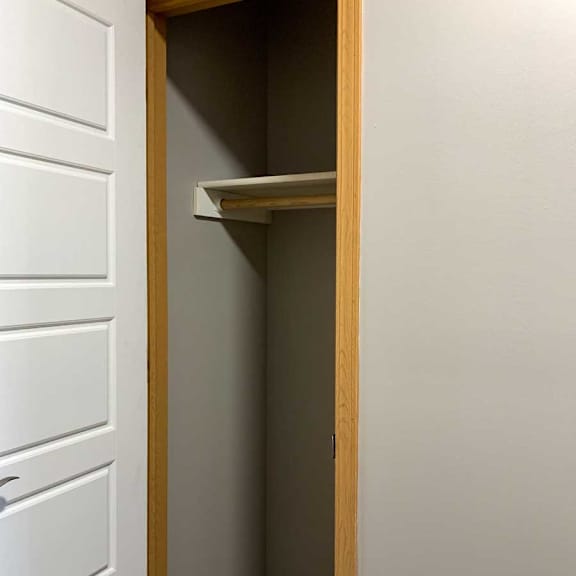 Thumbnail 13 of 21 a hallway coat closet with a built-in shelf