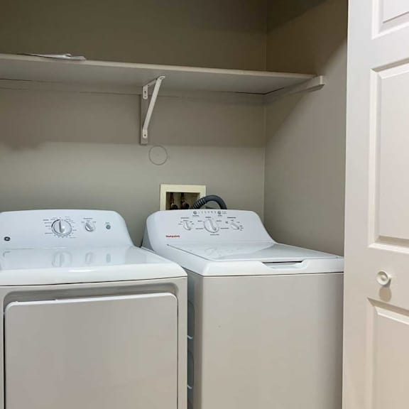 Thumbnail 19 of 21 a front-loading side-by-side washer and dryer with overhead storage