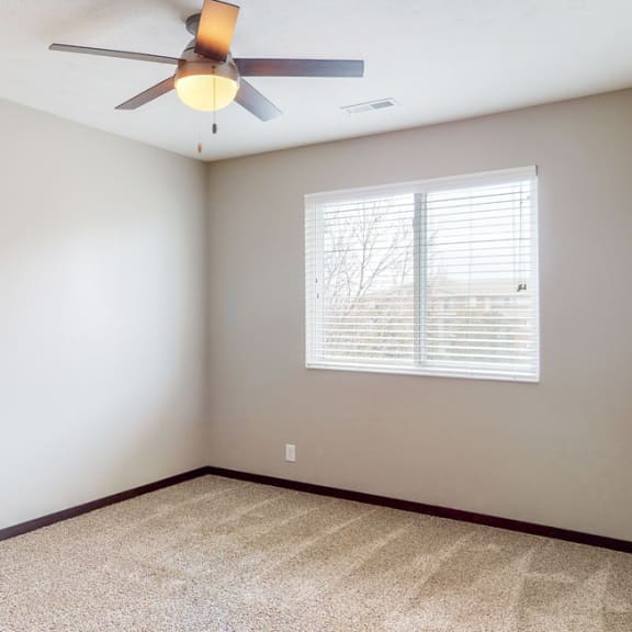 Thumbnail 7 of 10 Large renovated bedroom with ceiling fan at Northridge Heights apartments in Lincoln