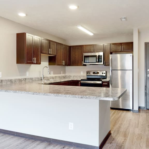 Thumbnail 3 of 10 Renovated kitchen with large peninsula island with ample storage at Northridge Heights