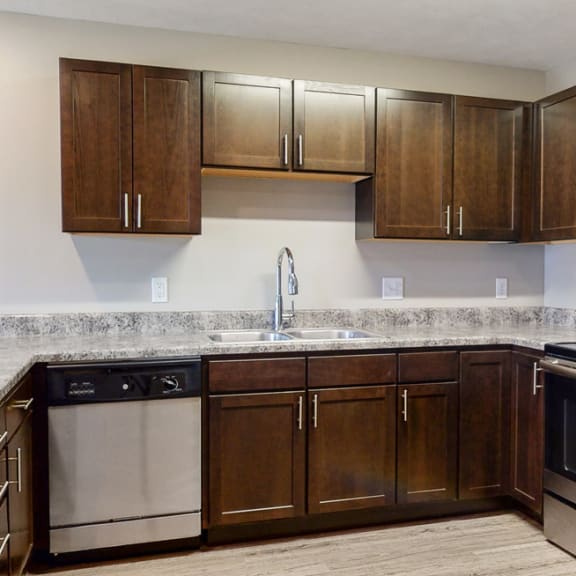 Thumbnail 4 of 10 Renovated kitchen with granite counters and new appliances at Northridge Heights Apartments