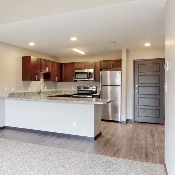 Thumbnail 2 of 10 Open dining and living area with carpeted floors at Northridge heights in lincoln nebraska