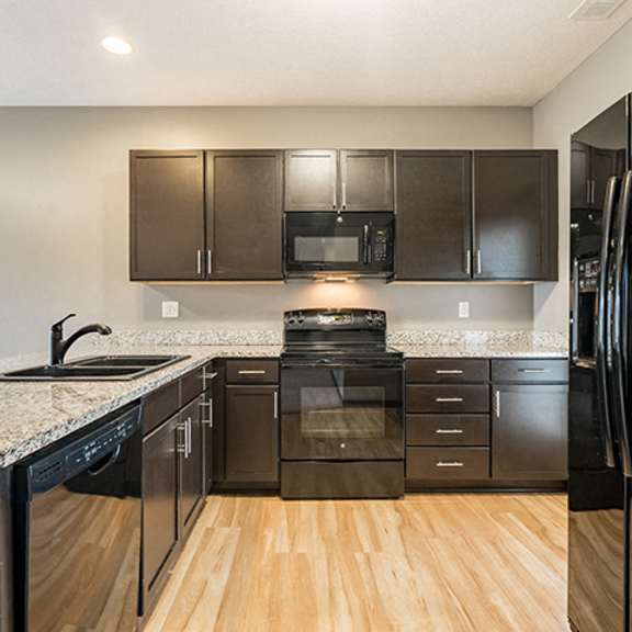 Thumbnail 6 of 11 Kitchen with hardwood-like flooring and GE appliances at The Villas of Omaha at Butler Ridge in Omaha Nebraska