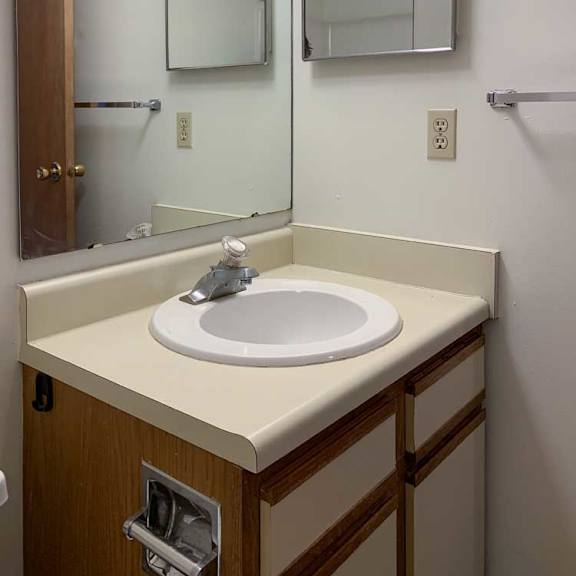 Thumbnail 16 of 30 a bathroom with a sink, a tall mirror, and a mirrored medicine cabinet