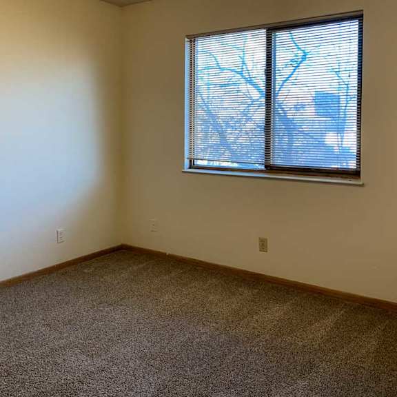 Thumbnail 20 of 30 a bedroomw ith a window and carpeted flooring