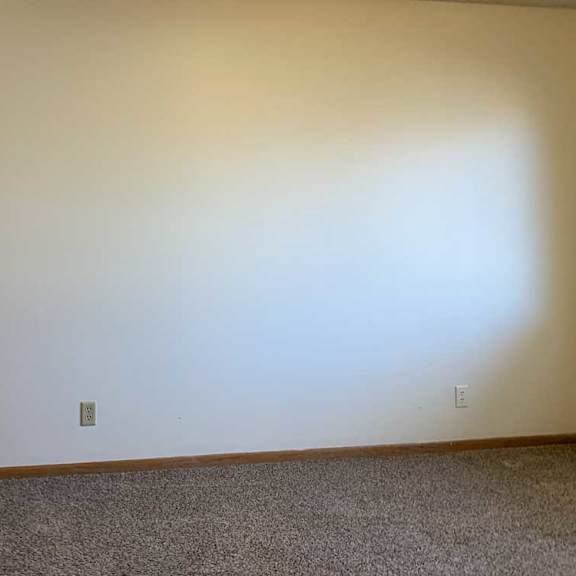 Thumbnail 28 of 30 a bedroom with a carpeted floor and a door on the left