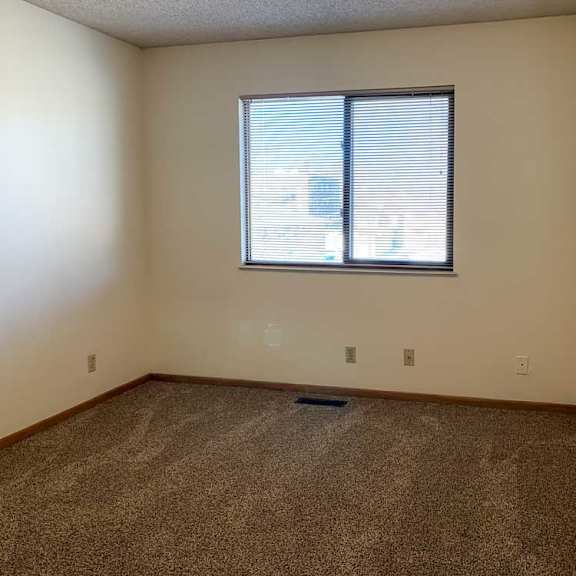 Thumbnail 29 of 30 a bedroom with a window and carpeted floor