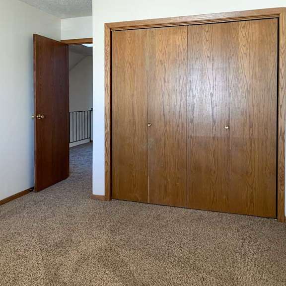 Thumbnail 26 of 30 a bedroom with a door open to the loft area and a closed closet