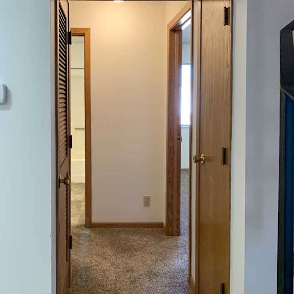 Thumbnail 10 of 30 a hallway with doors to the two bedrooms on the main level