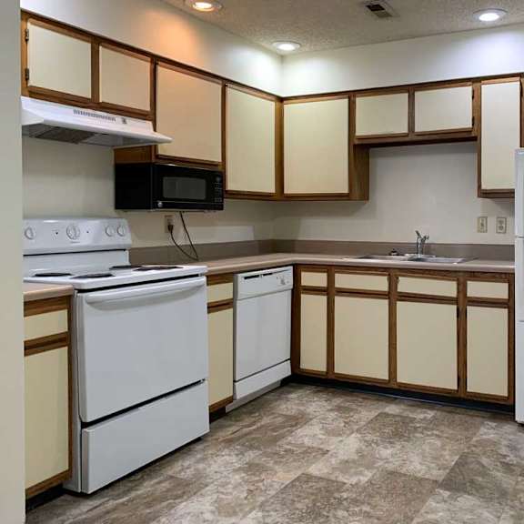 Thumbnail 3 of 30 a kitchen with white appliances and white and wooden cabinets