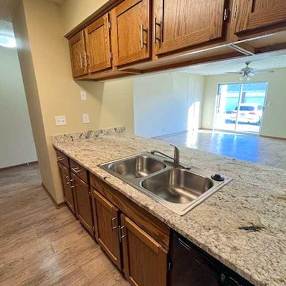 Thumbnail 3 of 17 a kitchen with wooden cabinets and updated countertops