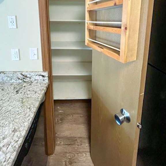 Thumbnail 4 of 17 a kitchen with a pantry with additional storage shelves hanging on the door