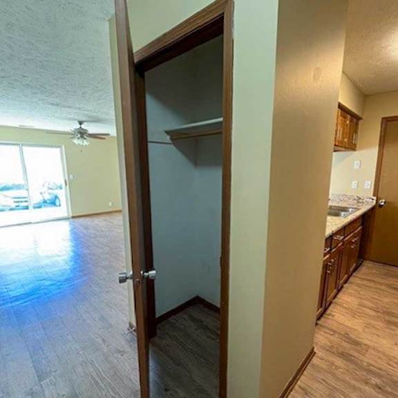 Thumbnail 5 of 17 a coat closet next to the kitchen and living room