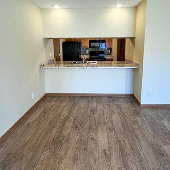 Thumbnail 8 of 17 a kitchen with a windowed bar countertop facing the living room