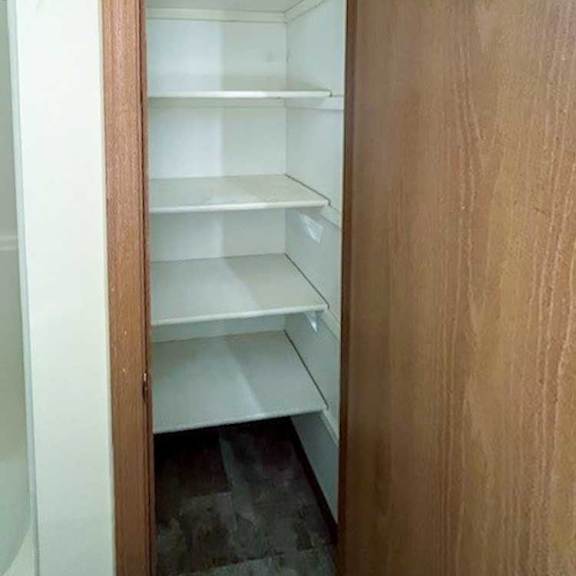 Thumbnail 15 of 17 a bathroom linen closet with built-in shelves