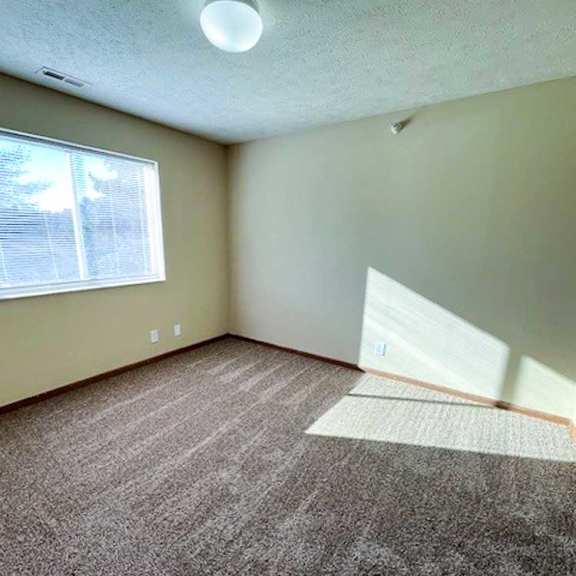 Thumbnail 13 of 17 a bedroom with a carpeted floor and a window