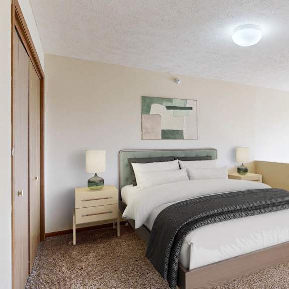 Thumbnail 22 of 40 A bedroom with a large bed and a nightstand with a lamp.