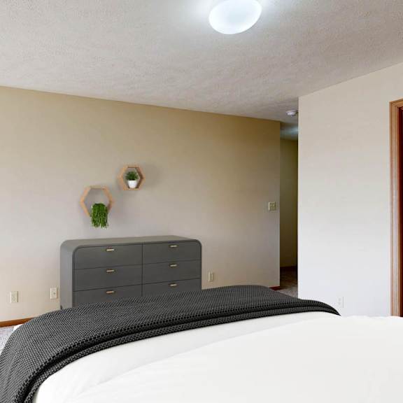 Thumbnail 24 of 40 A bedroom with a bed, nightstand, and chair.