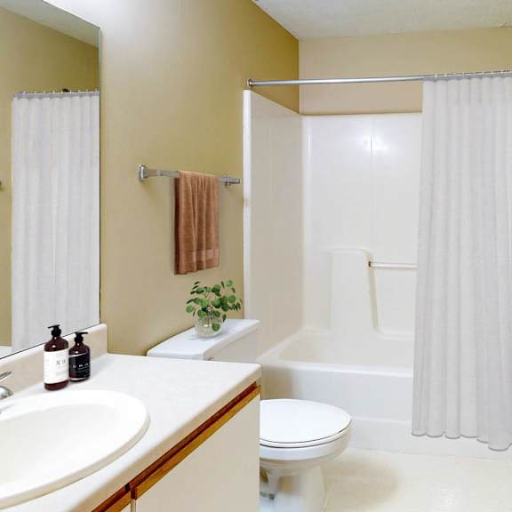 Thumbnail 31 of 40 A bathroom with a toilet, sink, and bathtub.