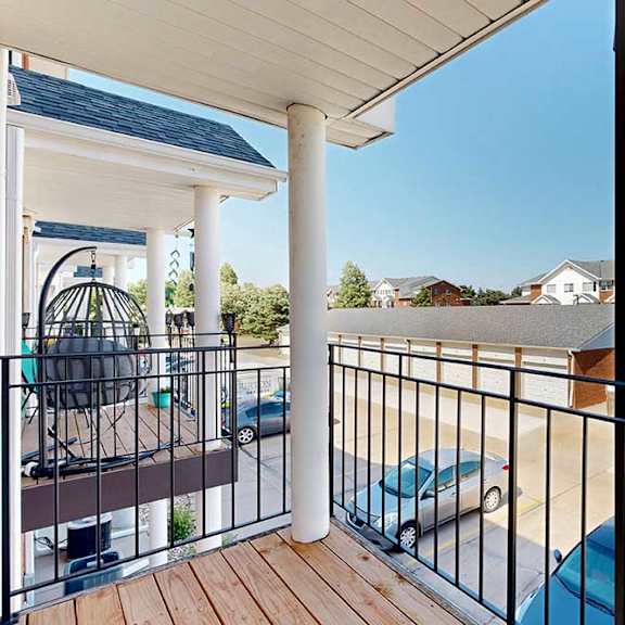 Thumbnail 15 of 33 A balcony with a metal railing and a view of neighboring apartments.