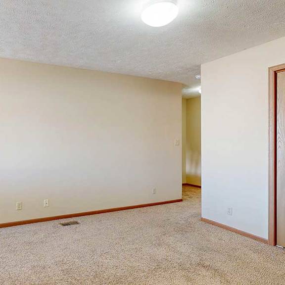 Thumbnail 23 of 33 A loft bedroom with carpeted flooring and a closet.