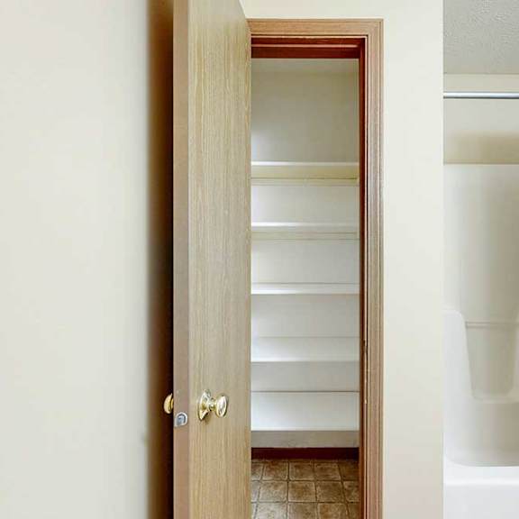 Thumbnail 21 of 21 A bathroom with a linen closet, with several built-in shelves.