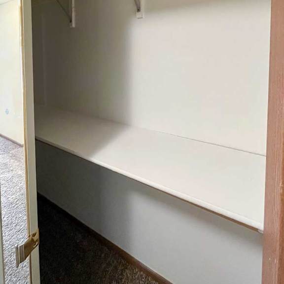 Thumbnail 12 of 13 a hallway closet with built-in shelves and hanging rods
